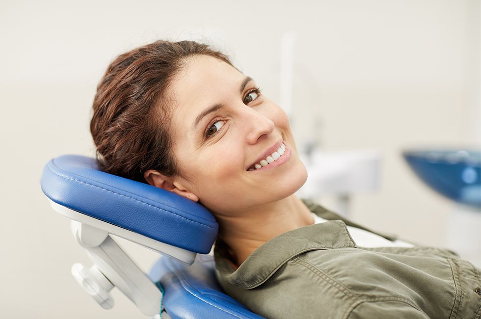 Woman in dental chair smiling