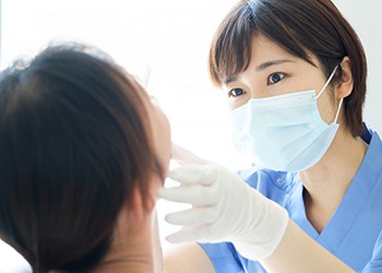 A female dentist examining a patient’s smile 