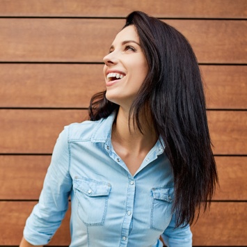 Smiling woman in denim shirt