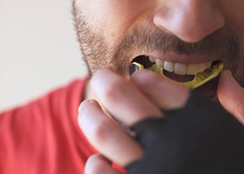 Dental implant patient in Midland wearing a mouthguard