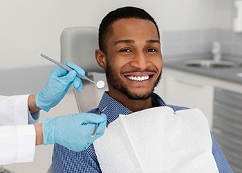 Dental implant patient in Midland smiling at the dentist
