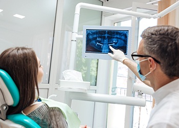 dentist showing a patient their dental X-rays 