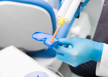 Dental team member preparing impression tray