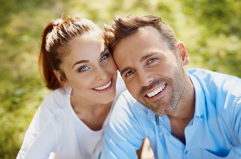 Smiling man and woman outdoors