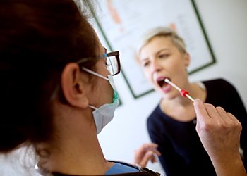 Woman receiving oral DNA swab