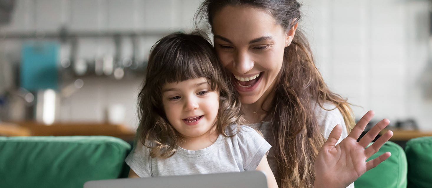 Mother and young daughter looking at computer