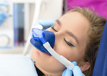 Woman with nitrous oxide nose mask