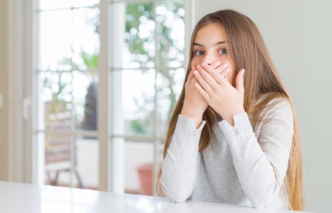 Woman covering mouth