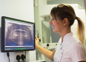 Dental team member looking at digital x-rays