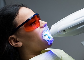 Woman receiving teeth whitening treatment