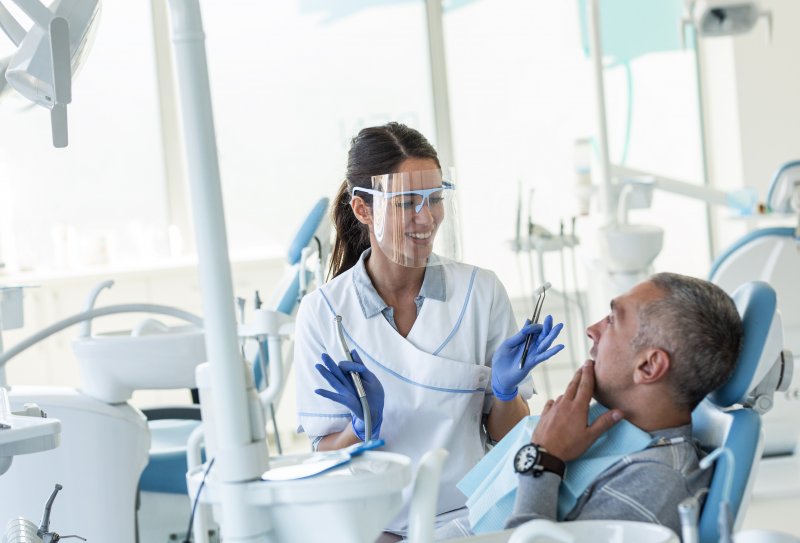 Dentist in Midland wearing PPE with patient.