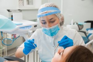 Midland dentist in PPE during a checkup during COVID-19