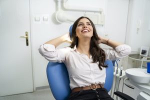 Woman smiles and relaxes while visiting Midland sedation dentist