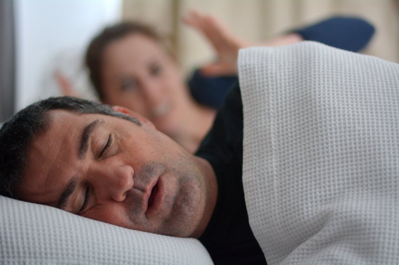 man with sleep apnea snoring