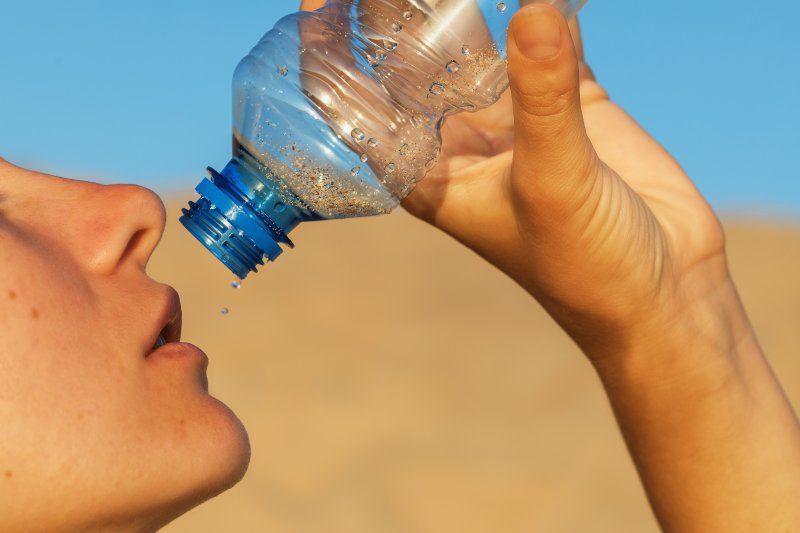 person drinking water due to dehydration