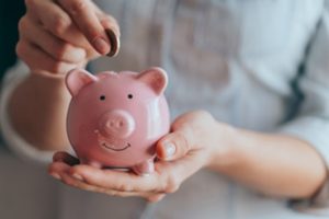 A patient in Midland saving money in a piggy bank 