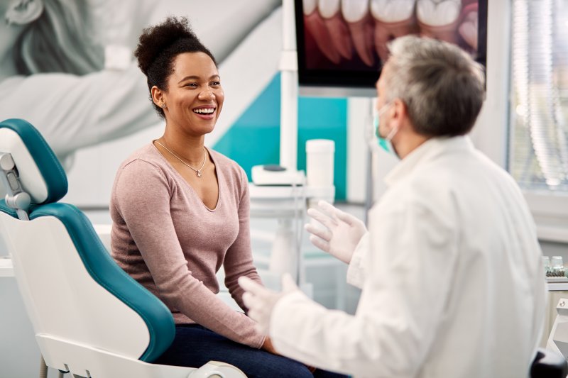 A dentist in Midland speaking with a patient