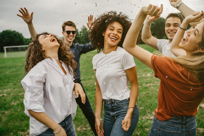 A group of smiling friends having fun at the park