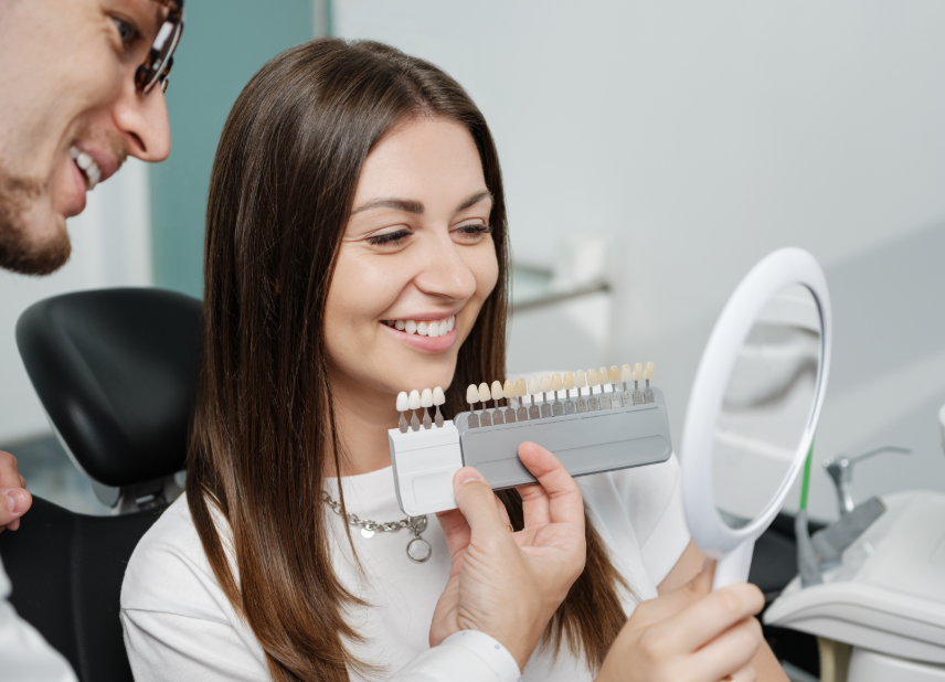 Dentist showing patient veneer options